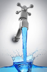 Conservation water concept. Metal faucet with water stream on gray background.
