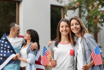 Modern family with USA flags outdoors