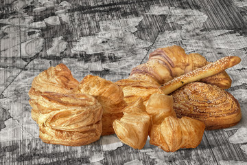 Bunch of Sesame Croissant Puff Pastry On Old Scratched Cracked Flaky Wooden Surface