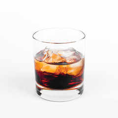 Black Russian vodka with ice in glass on white background