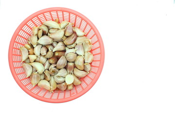 garlic in the pink plastic bsket isolated on white background