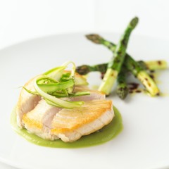 Swordfish with asparagus and green chickpeas on white background