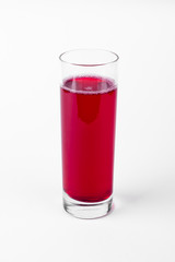 Red cranberry juice cocktail in glass on white background