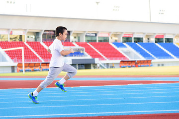 Boy runnin on blue track