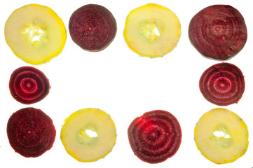 Rectangular frame made of round pieces of sliced beets and zucchini on a white background