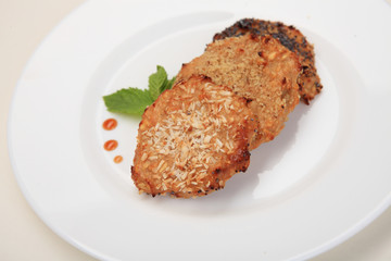 Cottage cheese and banana cookies with herbs on white plate