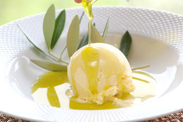 Over the lemon olive oil to vanilla ice on white plate