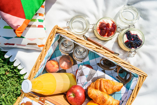 Picnic Basket With Fruits, Orange Juice, Croissants And No Bake Blueberry And Strawberry Jam Cheesecake
