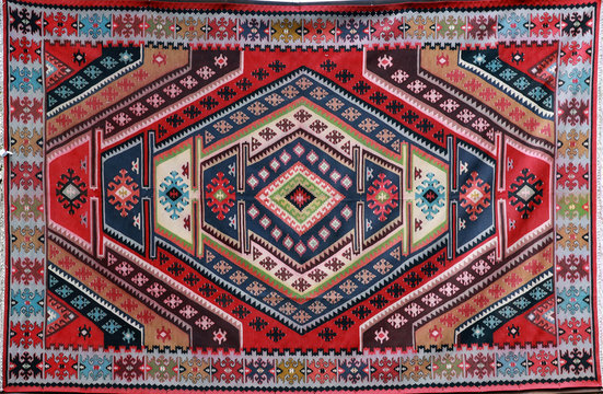 Hand-woven carpet with ethnic and folk pattern