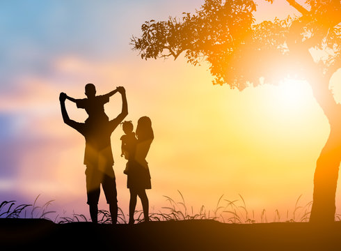Silhouette family mother, father and son, daughter playing happy