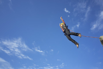 Jump rope from a high rock in the mountains.
