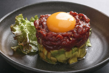 Avocado tartare stab Sakura beef meat with red egg and lettuce o