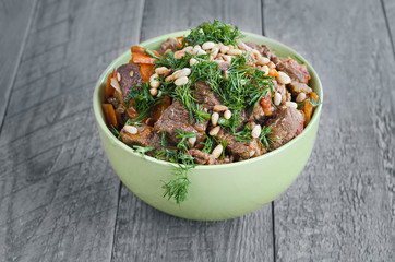 Veal stewed with vegetables, sprinkle  herbs and pine nuts