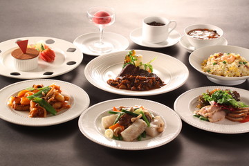 Platters of sauteed salmon, vegetables with fried rice and muffi