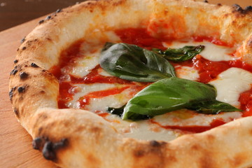 Fried pizza with hot chili and tomatoes sauce on wooden table