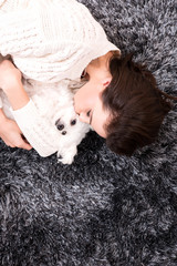 Young beautiful woman hugging her puppy