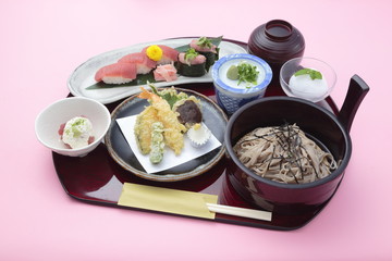 Tray meal of Japanese style with rice, sushi and soy sauces