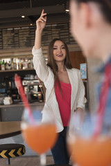 girl walking to her mate in a cafe