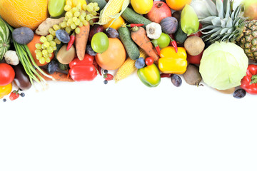 Ripe and tasty fruits and vegetables on a white background