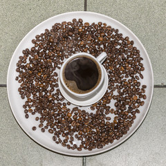 Coffee cup and coffee beans, top view