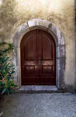 Fototapeta na wymiar Old vintage doors in a stone wall fence.