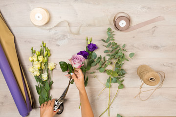 Fototapeta premium Flowers and floristic equipment arranged on a wooden background