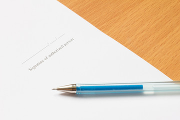 Pen on paper with Signature of authorized person wording