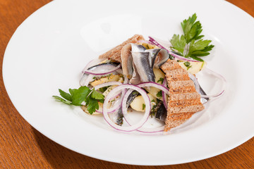 Salad with potatoes sprat and onions