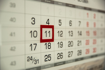 Calendar date is highlighted in red wall close to the square of black figures