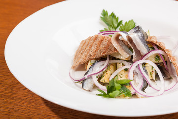 Salad with potatoes sprat and onions