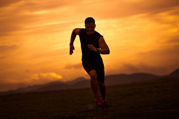 Asian men are siluate jogging at a speed in the evening