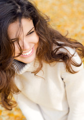 Close up portrait of a happy woman in autumn