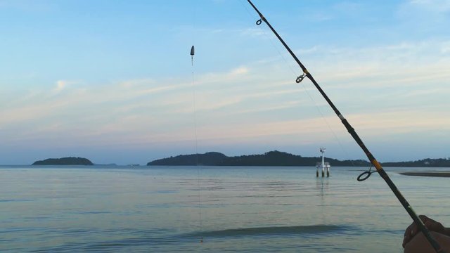 when the sea high tide sea fish come around the bamboo wire angler put bait hook and waiting for fish bait until sunset