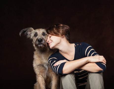 portrait of a beautiful young woman with a funny shaggy dog on a