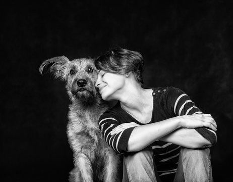 portrait of a beautiful young woman with a funny shaggy dog on a
