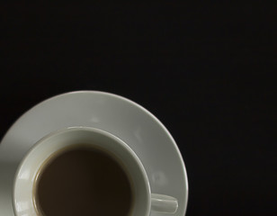 Cup of coffee on the black background