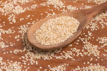 Quinoa Flakes into a spoon.