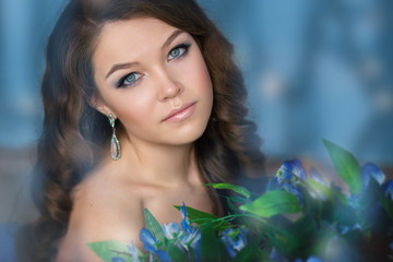 Portrait of the young beautiful woman with blue eyes