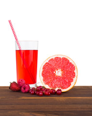 Fresh juice and fruit on a wooden table isolated on white background