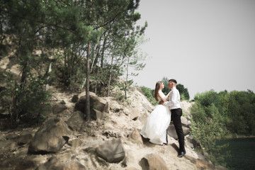 beautiful wedding couple in the mountains with rocks