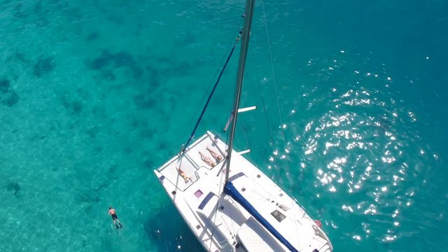 aerial view of a group of people relaxing on a catamaran in the Caribbean, Lovango Cay, United States Virgin Islands