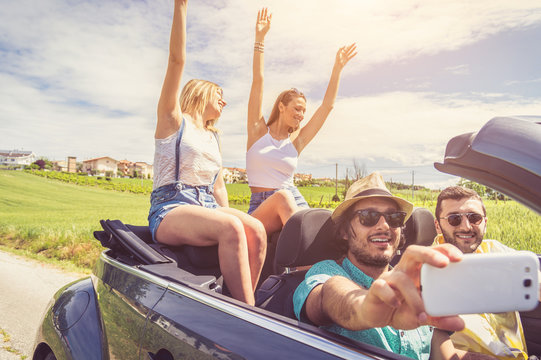 Friends taking a selfie at car trip