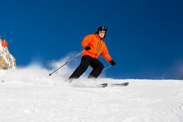 Fototapeta na wymiar Male skier skiing on ski slope