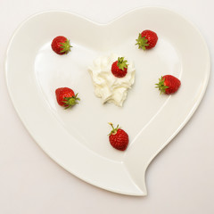 Heart shaped plate and red strawberry