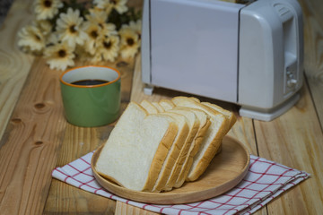 Toaster with slide bread on wood table with hot coffee - Selective focus