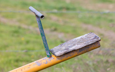 Old wooden and steel seesaw