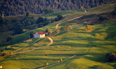 September rural scene in mountains. Authentic village and fence