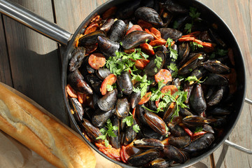 Mussels with chorizo cooking in a pan