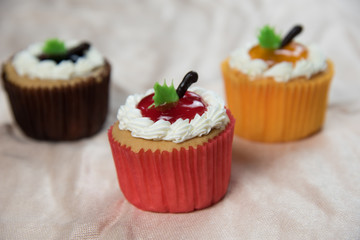 Three cupcakes on Beige tablecloth