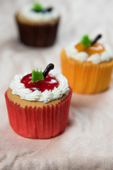 Three cupcakes on Beige tablecloth